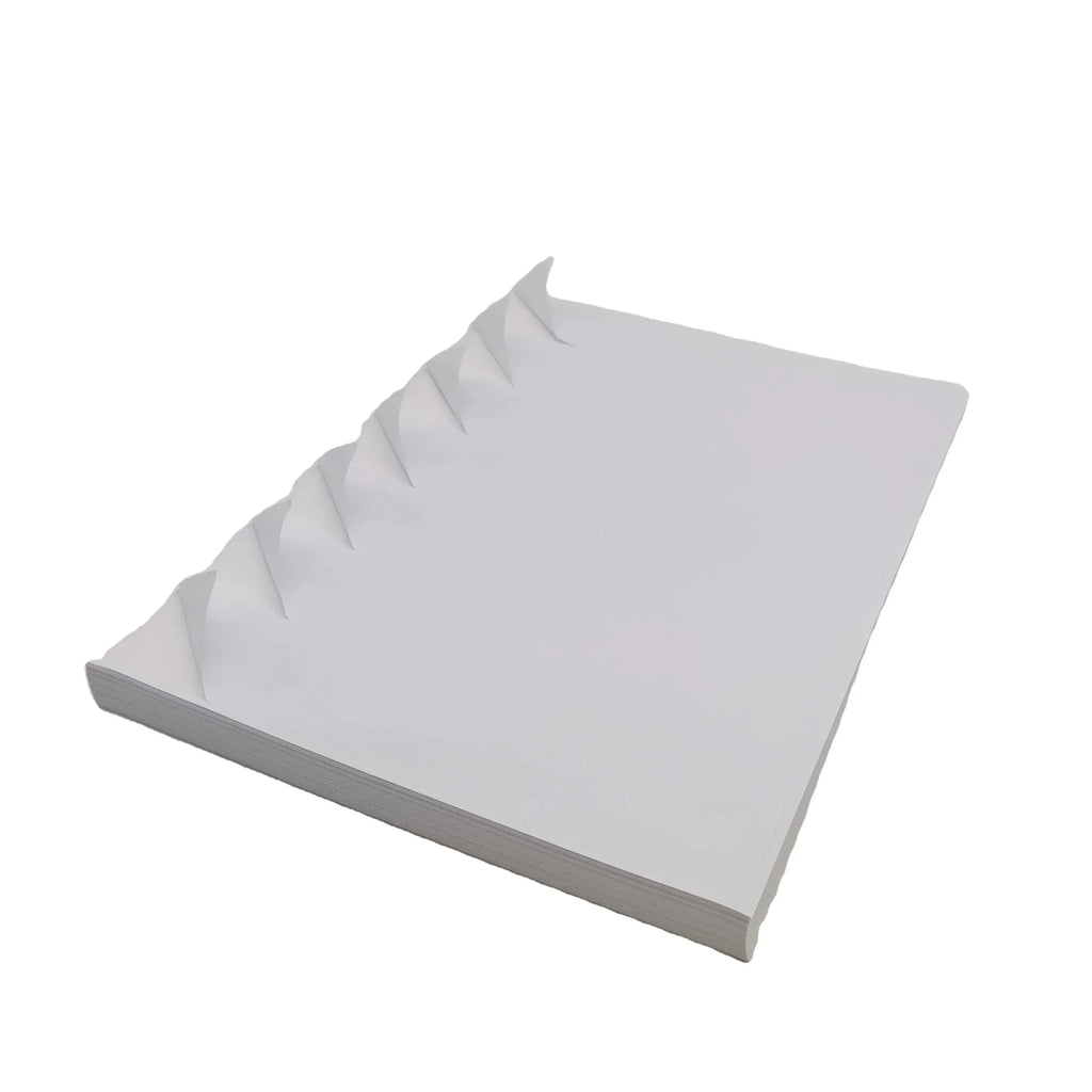 White A4 self-adhesive vinyl sticker sheets, angled stack with layered edges
