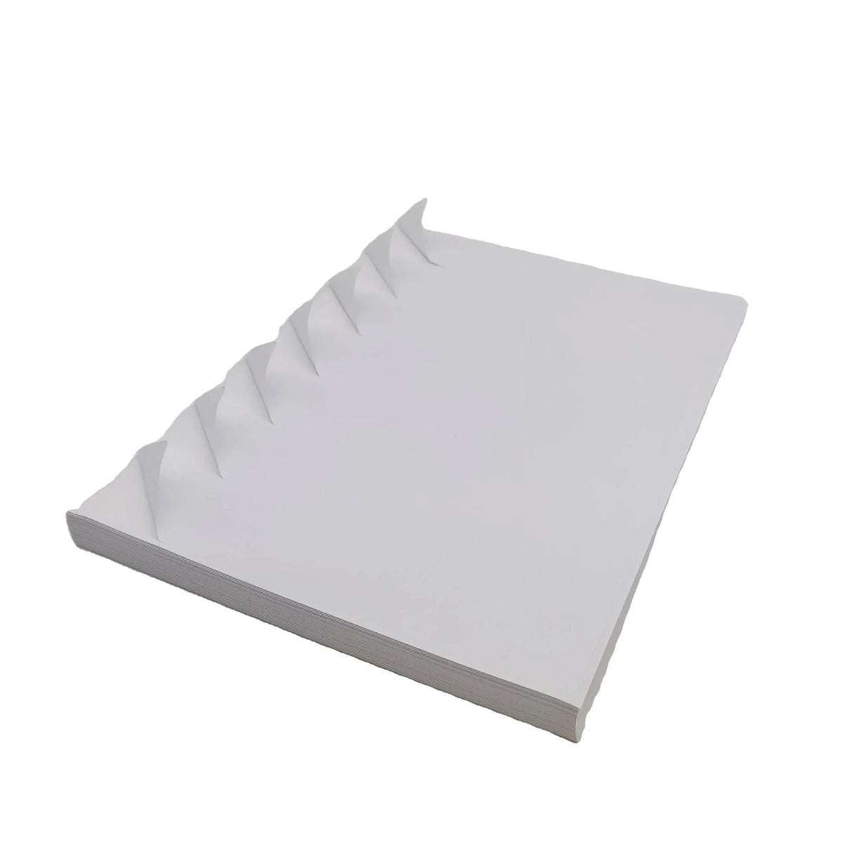 White A4 self-adhesive vinyl sticker sheets, angled stack with layered edges