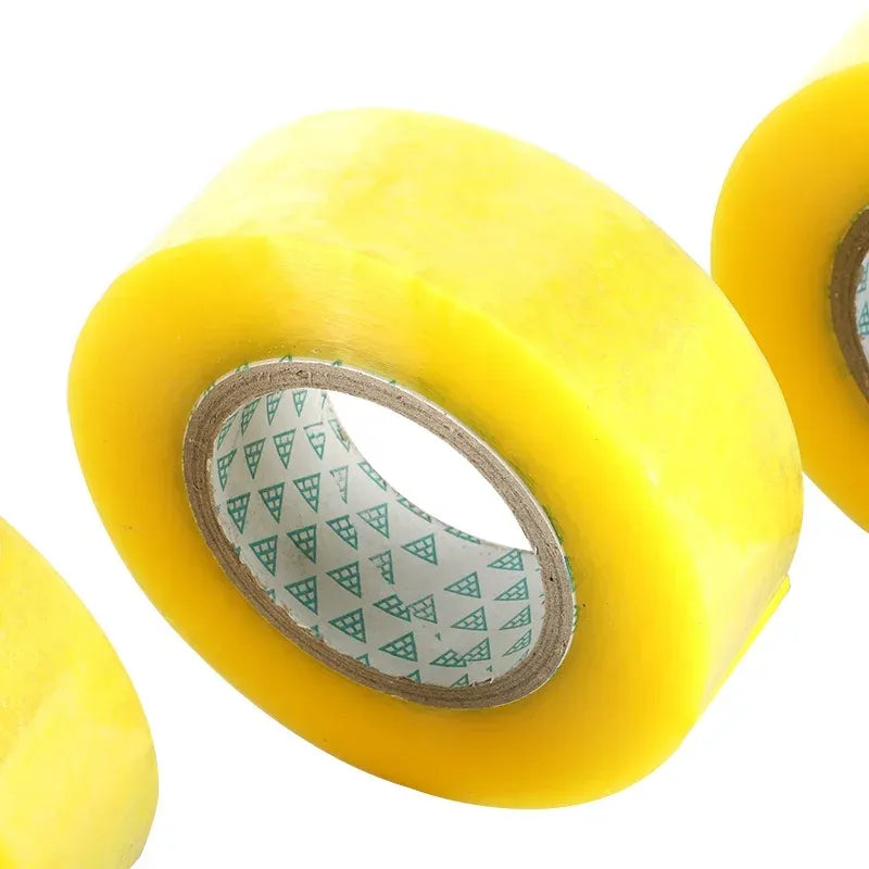 Yellow packing tape roll close-up with printed inner core strip