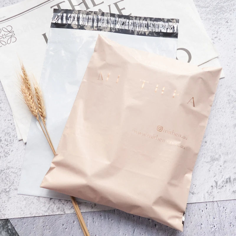 Nude poly mailer shipping envelope with printed branding on sealed front