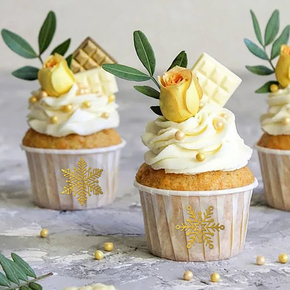 Gold foil snowflake circle stickers on frosted cupcakes