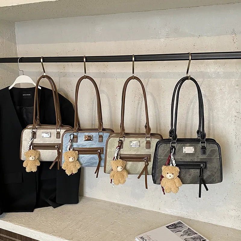 Soft leather multi-color tote bags with teddy bear charms and brown trim straps. Stylish messenger trunks for women.