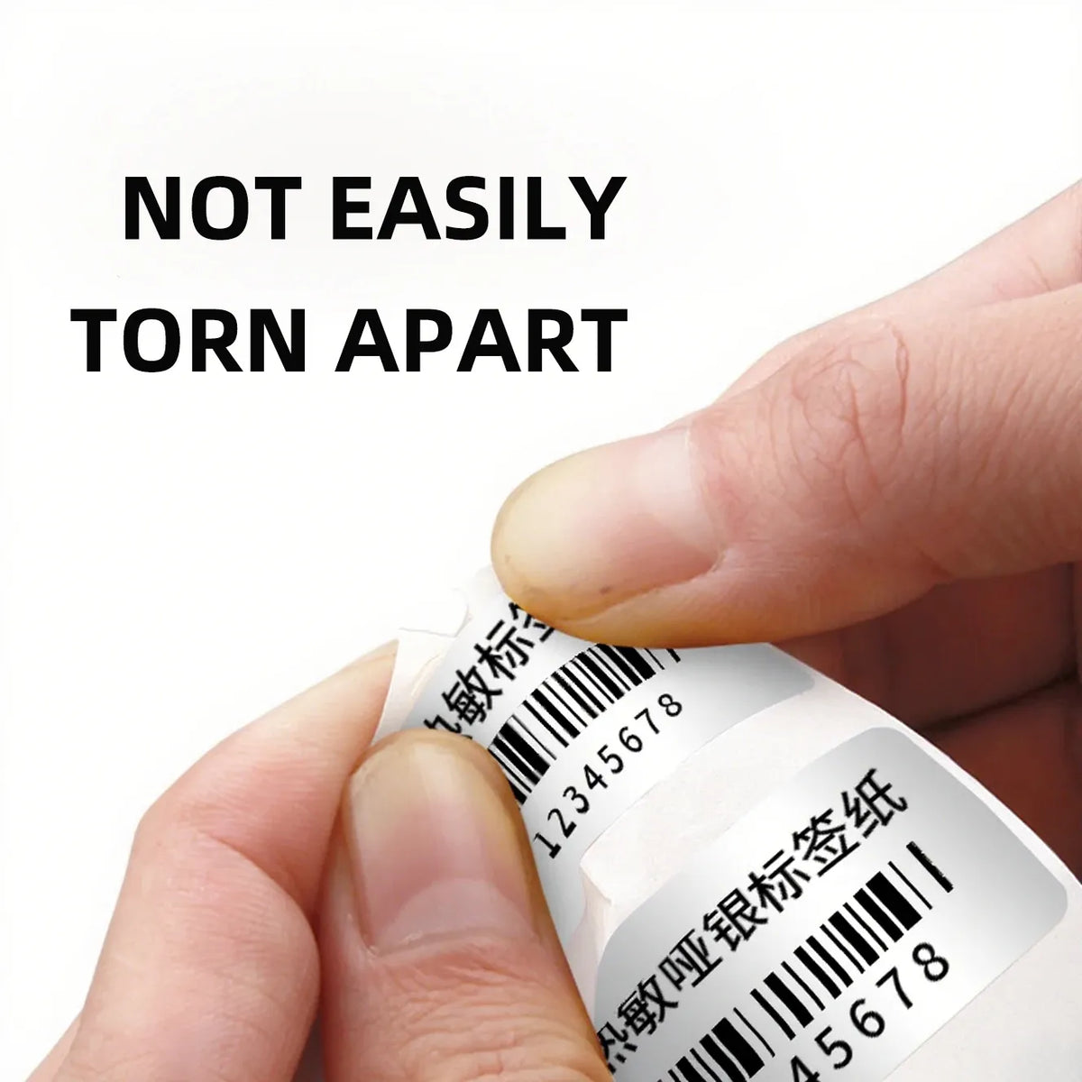 Hand holding matte silver thermal label with barcode and line details