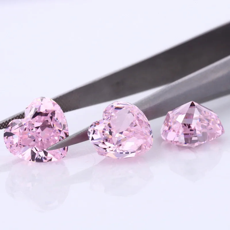 Three pink heart-shaped lab-grown diamonds, faceted loose stones on holder