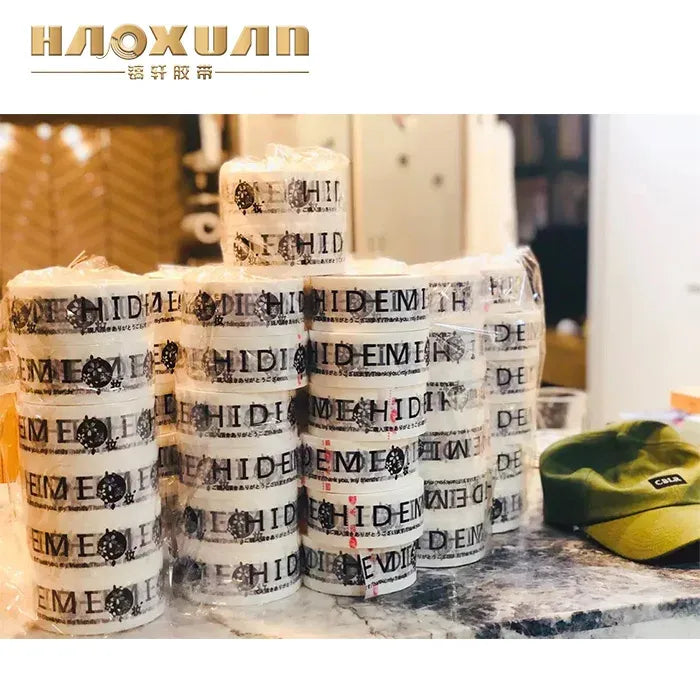 Stacked rolls of clear tape with repeating logo text