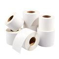 White rolls of adhesive label stickers with visible cardboard cores