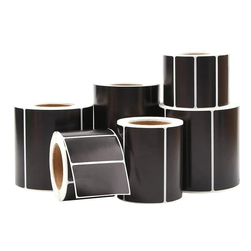 Assorted black thermal label rolls with blank rectangular label sections
