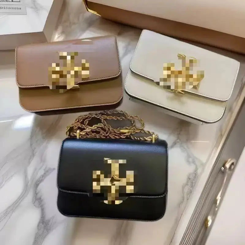 Zhenwo TB crossbody trunk bags in black, white, and tan leather with gold-tone metal logo plaques and chain straps.
