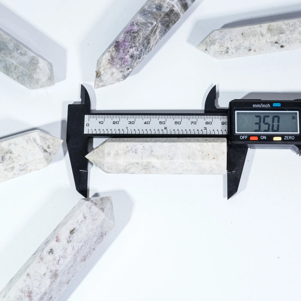 Purple sodalite crystal point tower with digital caliper size measurement