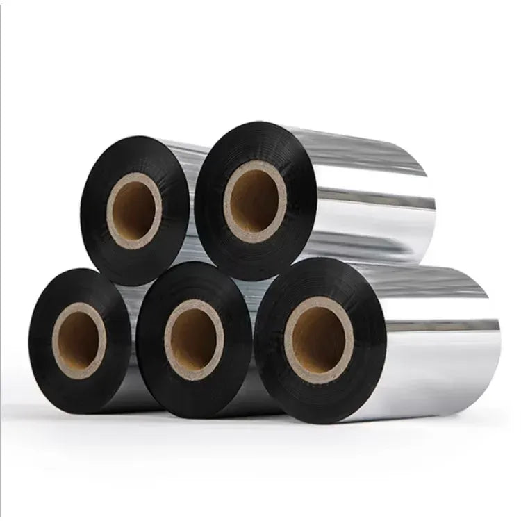 Stacked rolls of black thermal transfer ribbon with visible cardboard inner cores