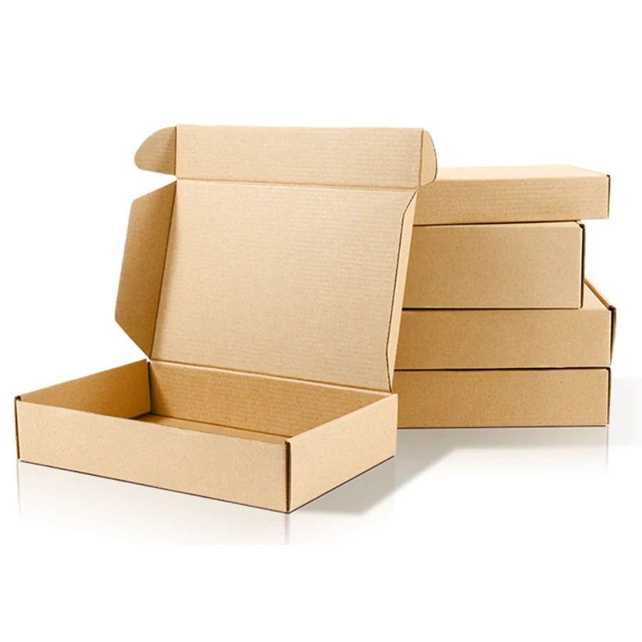 Open brown kraft mailer box with stacked kraft boxes behind, hinged lid