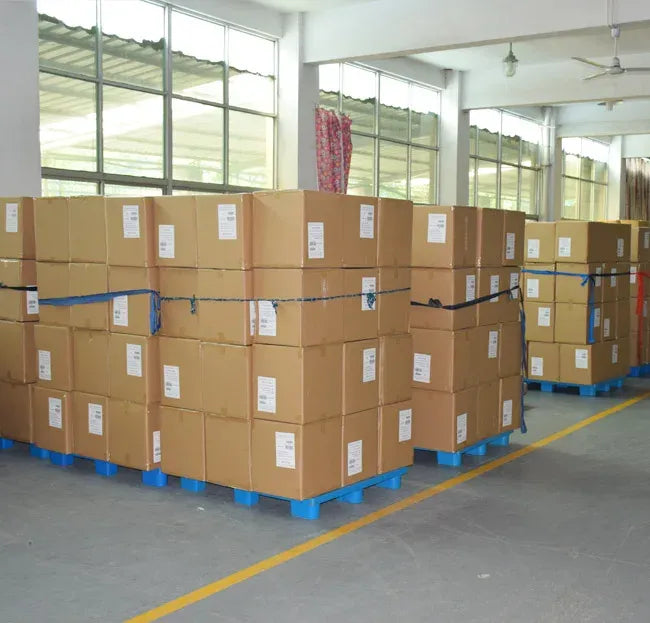 Warehouse interior with stacked cardboard boxes on pallets in rows