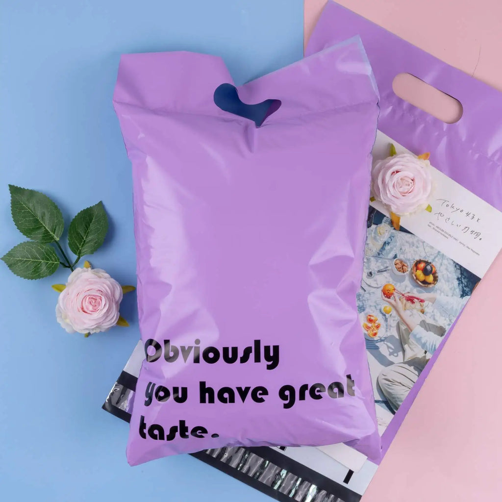 Lavender poly mailer bag with top handle cutout, “Obviously you have great taste” printed.