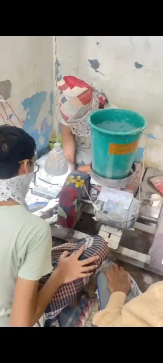 Gemstone jewelry making workspace with people and stone-cutting tools