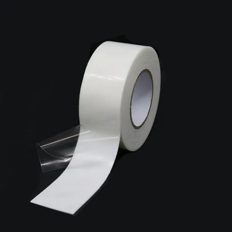 White double-sided foam mounting tape roll with an extended strip