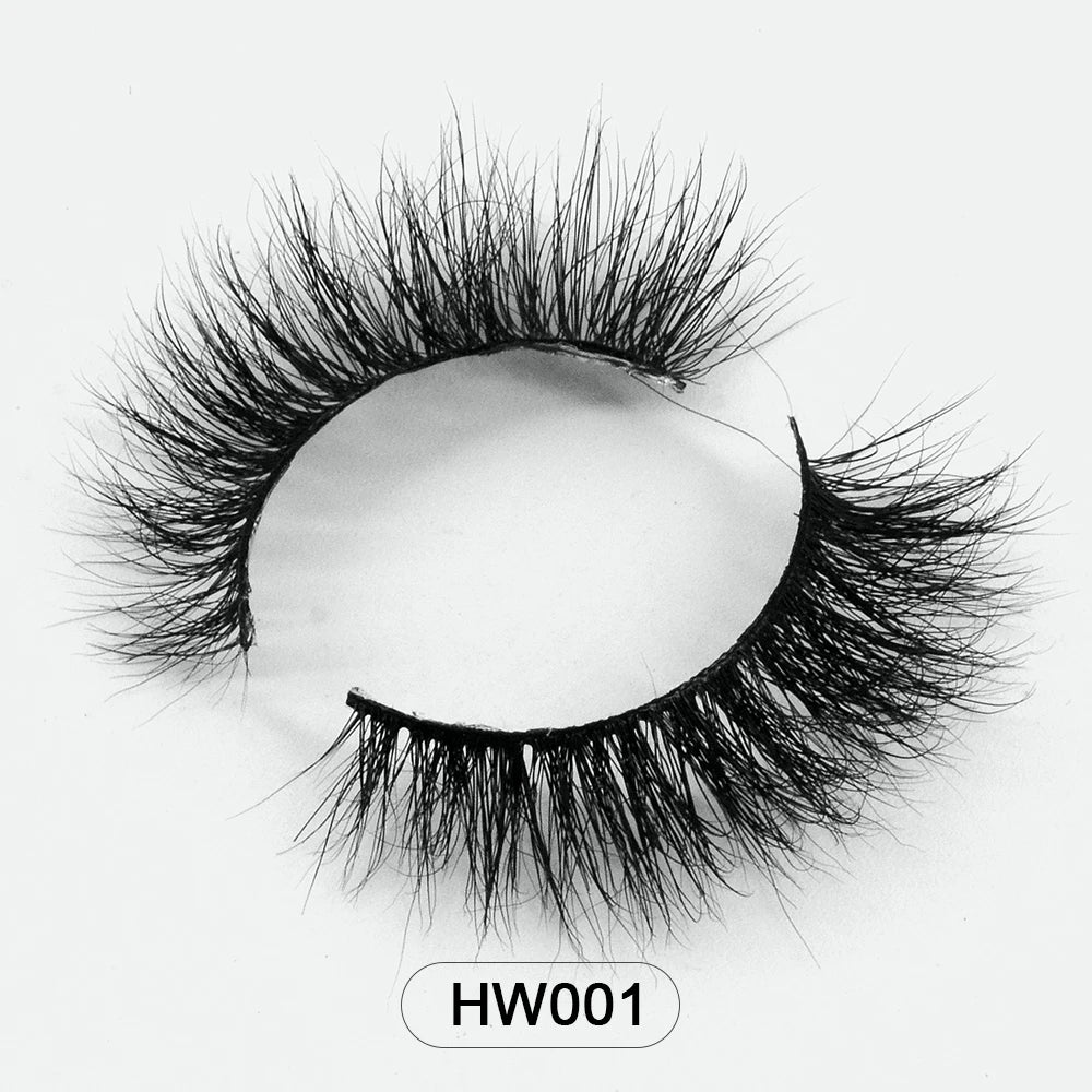 Fluffy black 3D mink false eyelashes with a flexible band, styled in a dramatic, wispy, curled arch. Label: HW001.