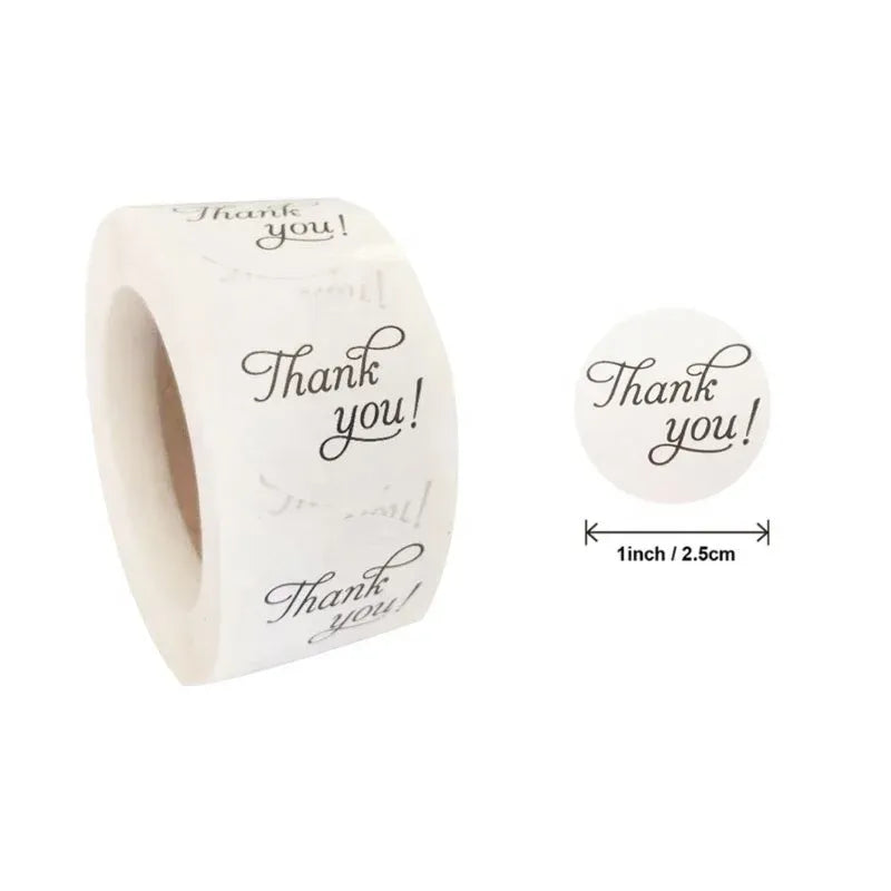 Thank-you sticker roll and small round label, white with black “Thank you!” script