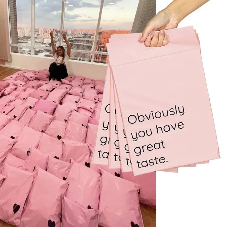 Pink poly mailer shipping bags with handles, held open showing “Obviously” text