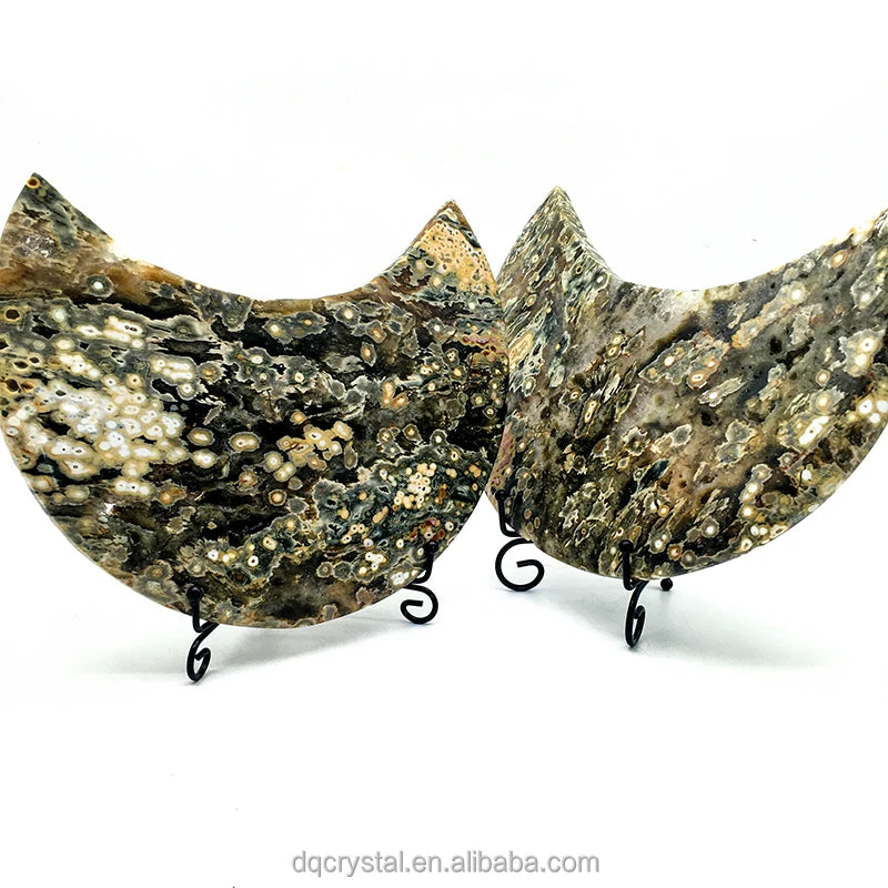 Two ocean jasper crescent moon crystals shown together, dark green and cream druzy speckles