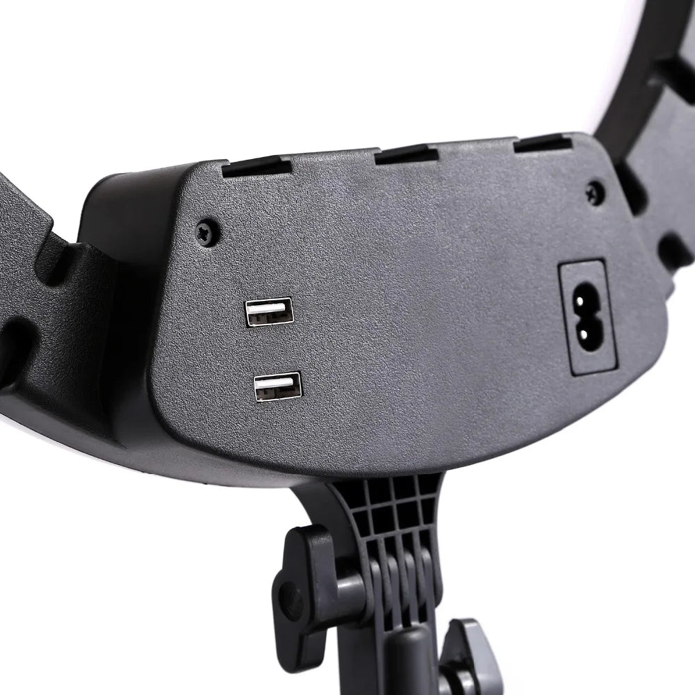 Black plastic ring light housing with two USB charging ports and a power input, mounted on an adjustable tripod stand.