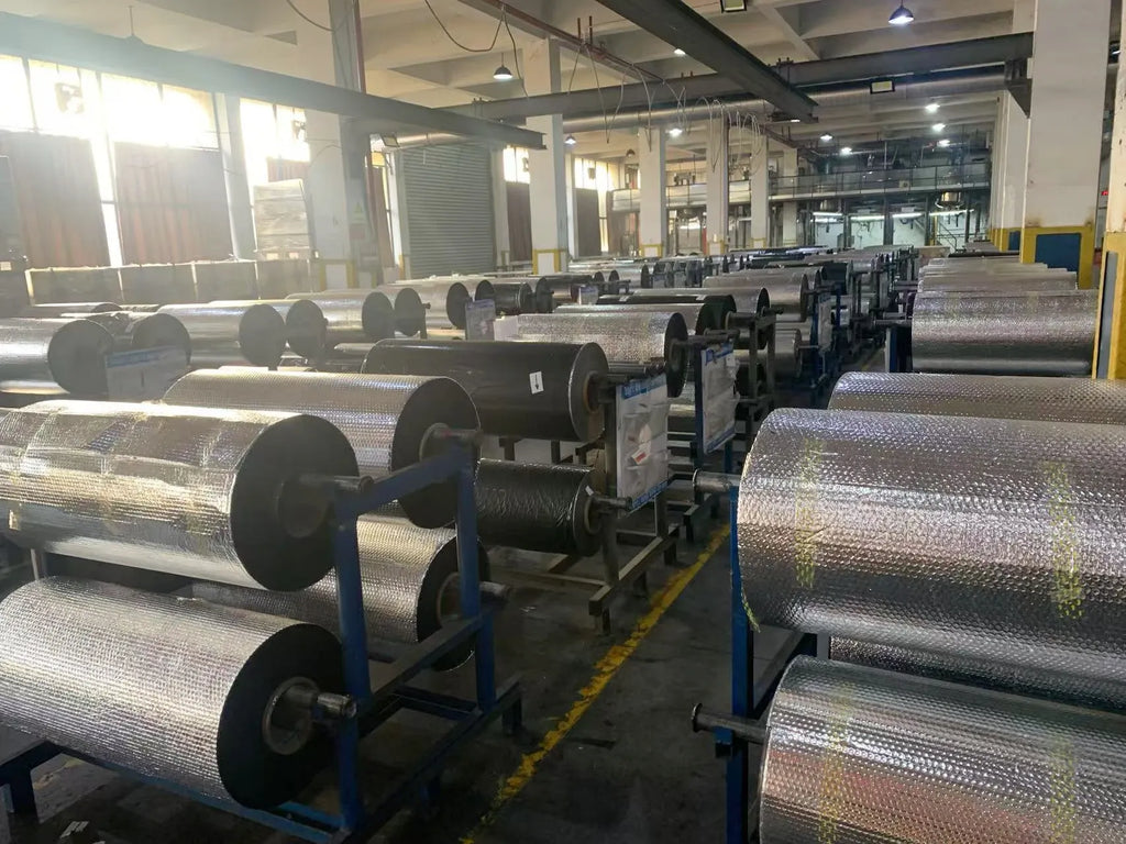 Thermal transfer ribbon rolls on large equipment frames with multiple metal shafts