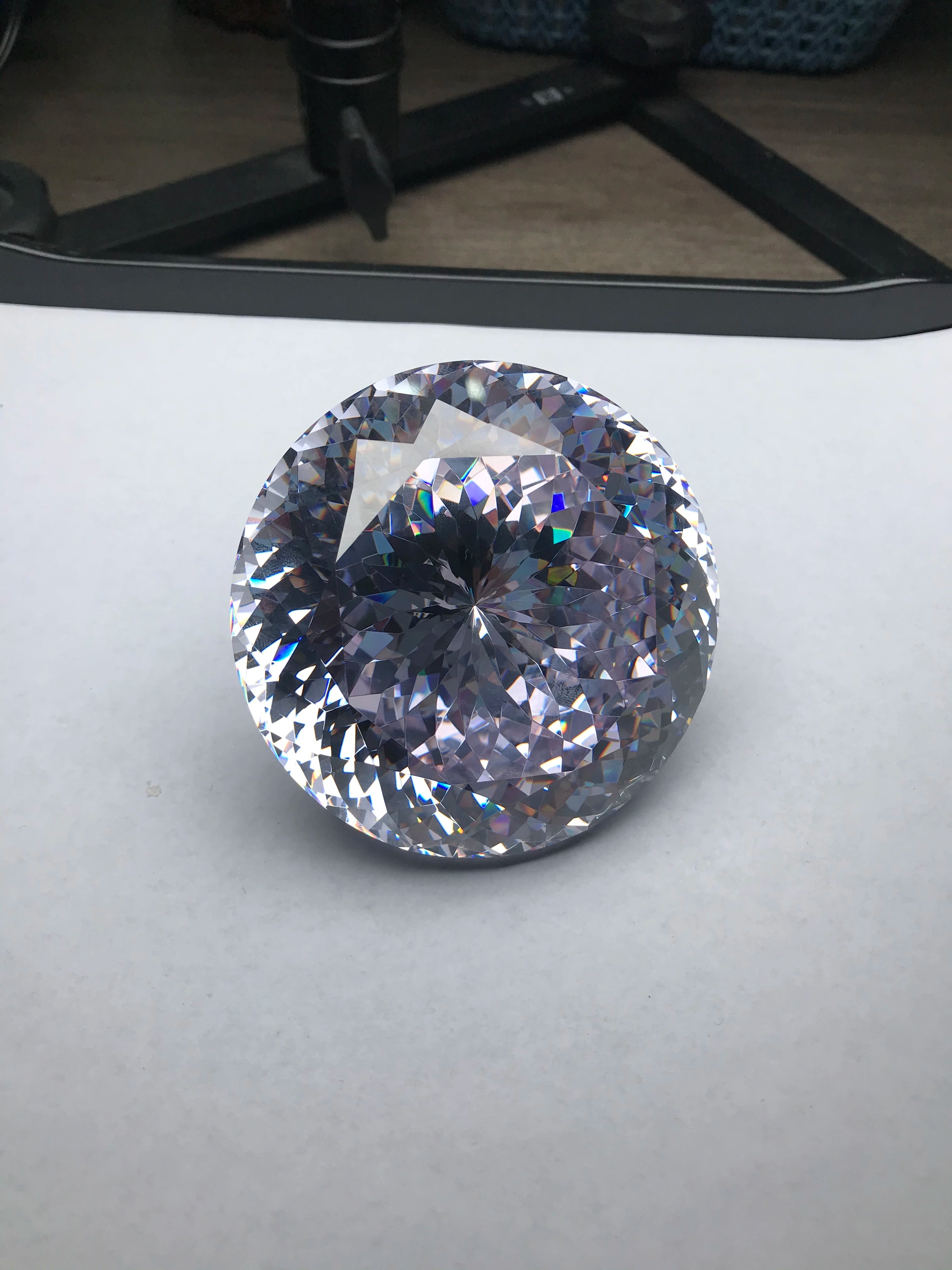 Large round brilliant-cut cubic zirconia gemstone, white, facets show strong reflections