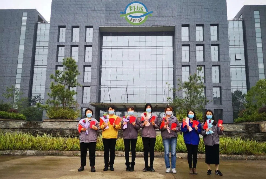 KEFAR building front with group wearing company-branded shirts