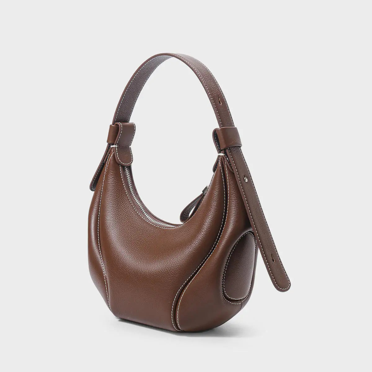 Brown leather half-moon crossbody handbag with contrast white stitching and structured hobo design.