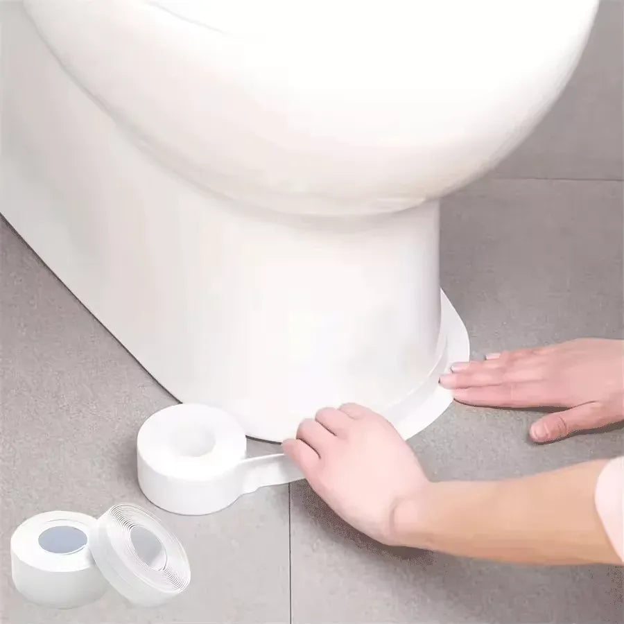White self-adhesive caulk sealant tape applied along toilet base seam