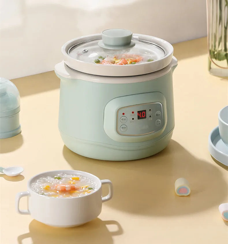 Mint electric slow cooker with lid and soup inside, digital panel shows 4.0