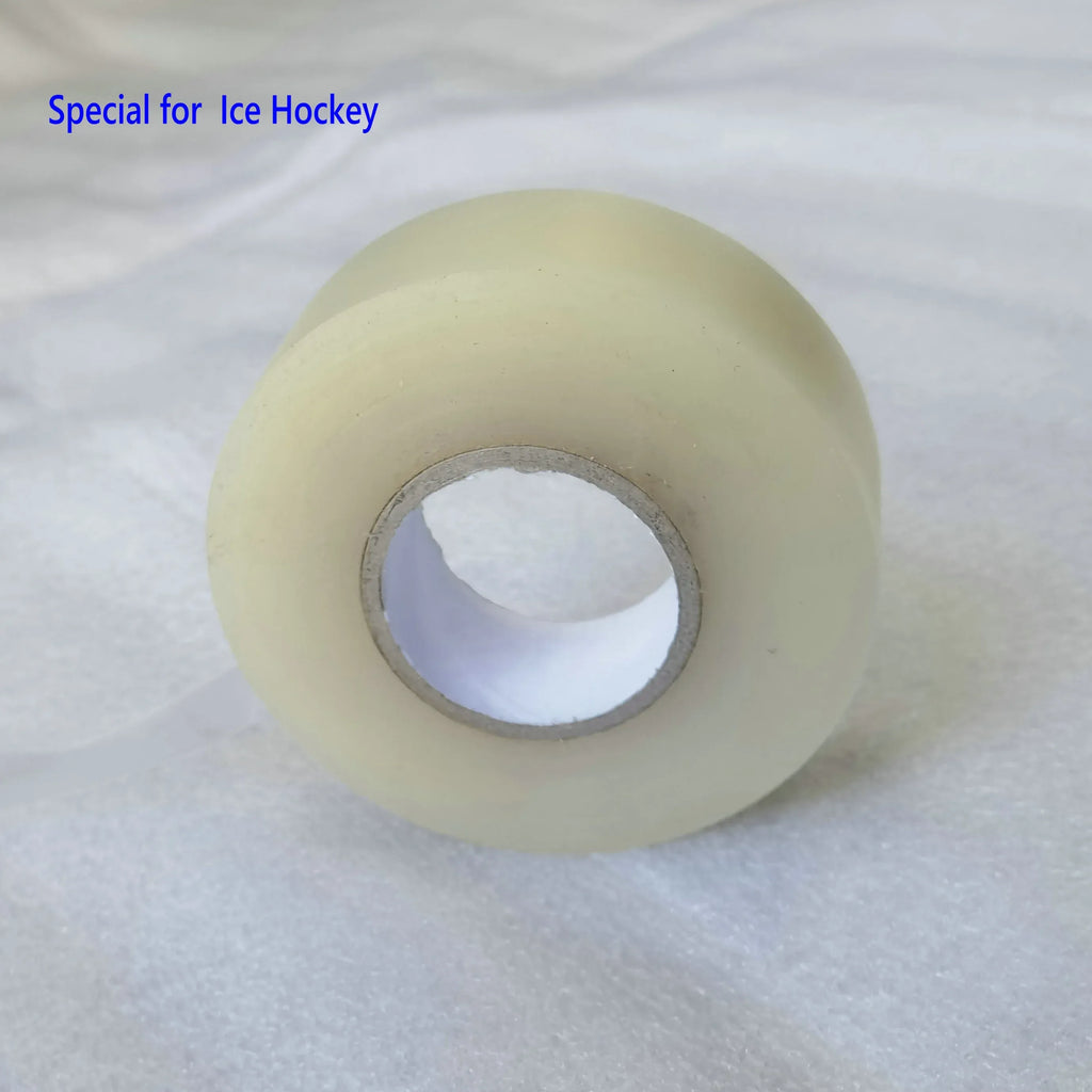 Pale yellow sports tape roll on a light surface with inner core visible