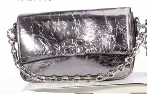Metallic silver crinkled leather designer shoulder bag with silver chain strap and metal logo clasp.