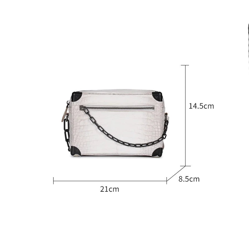 White genuine Himalayan crocodile leather trunk bag with black metal chain accents and reinforced corner hardware.