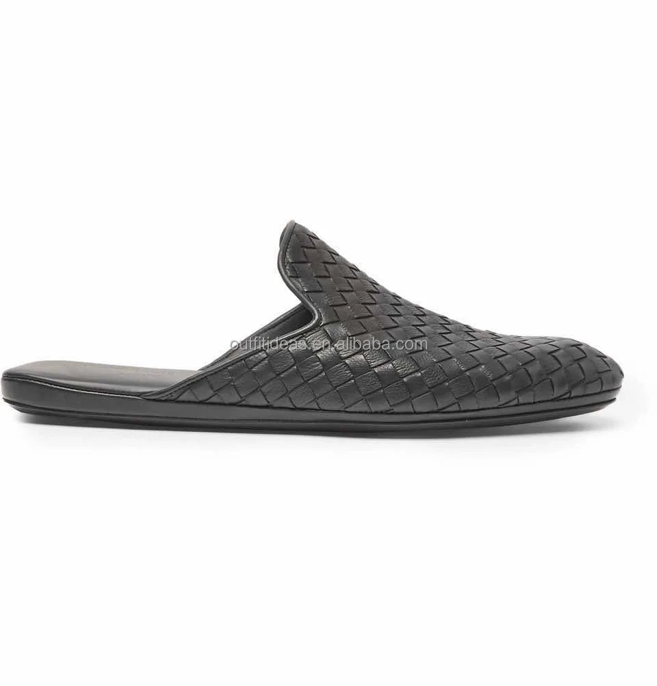 Luxury black woven leather mule loafers with flat sole and slip-on design.