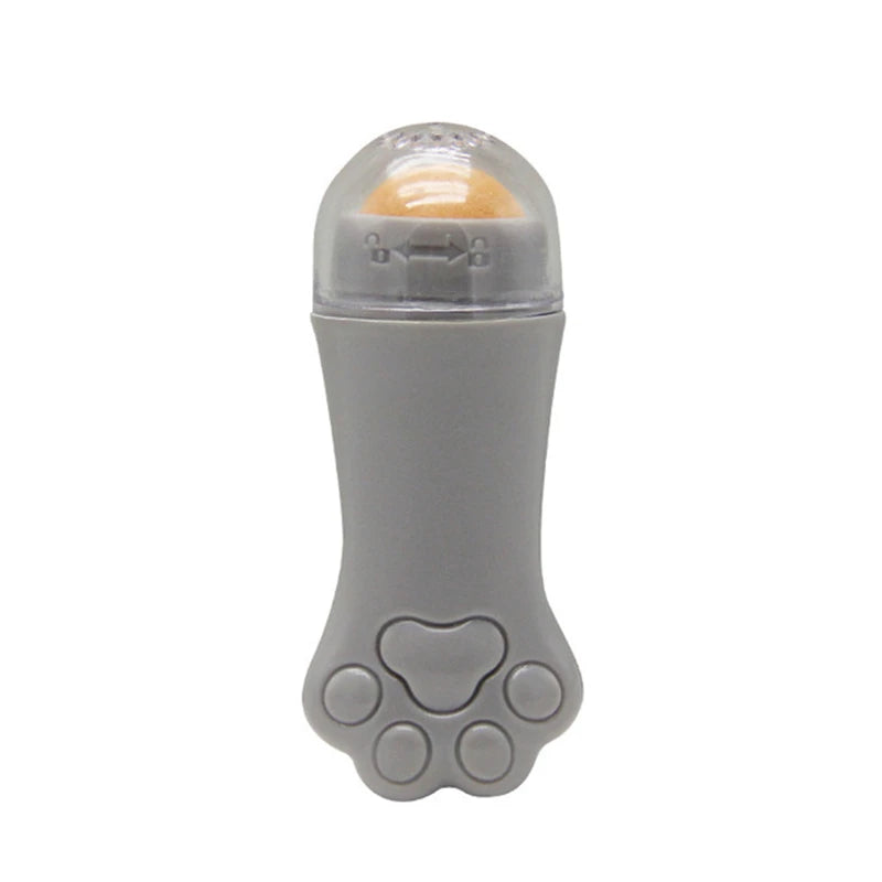 Gray cat paw-shaped face oil absorbing roller with a clear cap and a tan volcanic stone ball at the top.