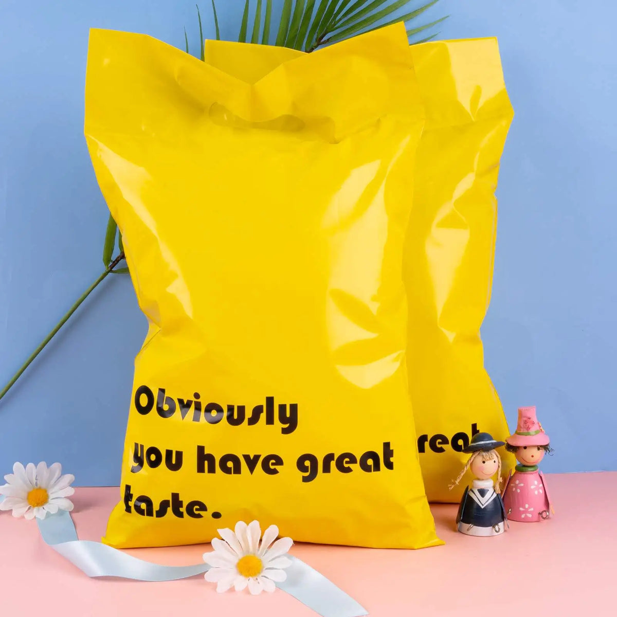 Yellow plastic mailing bag with handle cutout and “Obviously you have great taste.” text