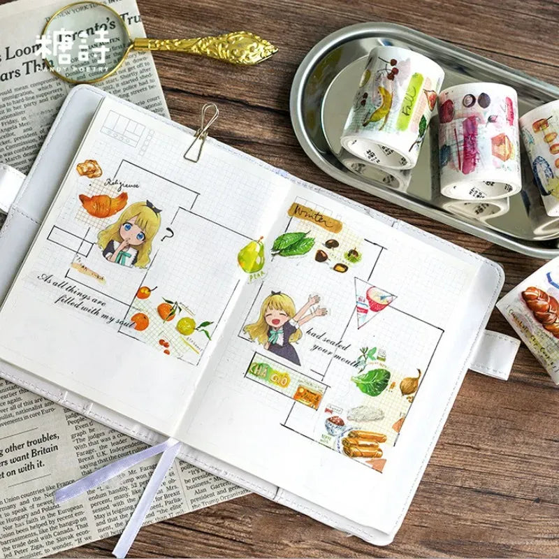 Food and snack masking tape rolls beside an open notebook layout
