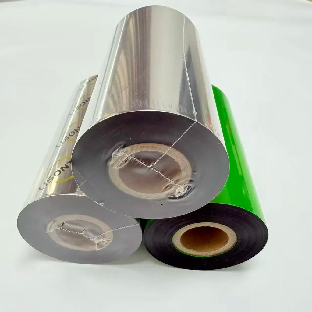 Stacked wax thermal transfer ribbon rolls with silver backing and green/black tapes