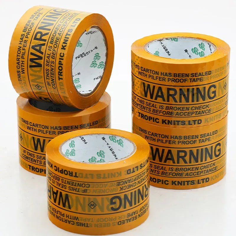 Yellow transparent warning tape rolls with repeating WARNING text