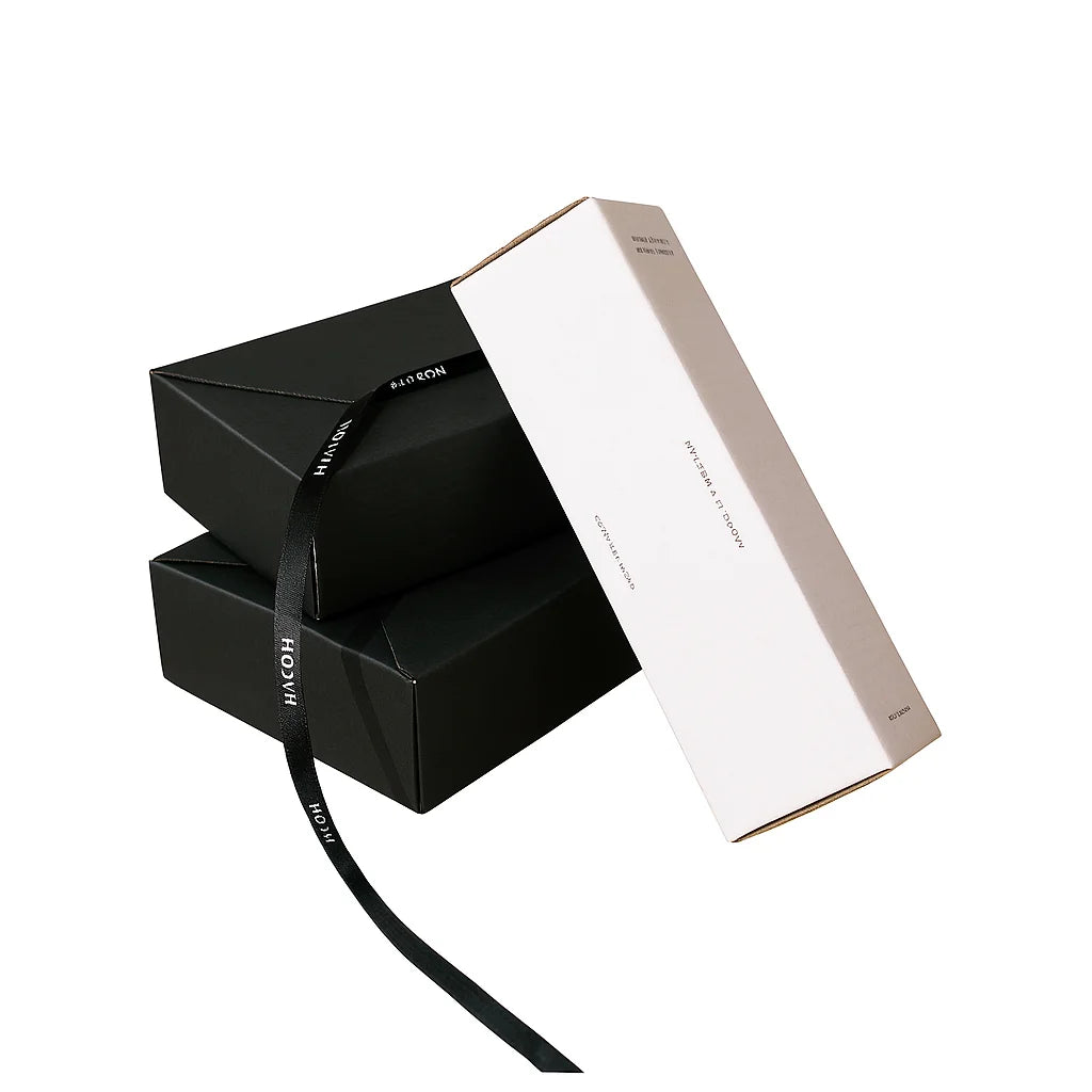 Shipping box mailer carton in black kraft with white outer panel and ribbon tie