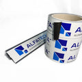 Spool of white protective tape with blue print and black backing strip