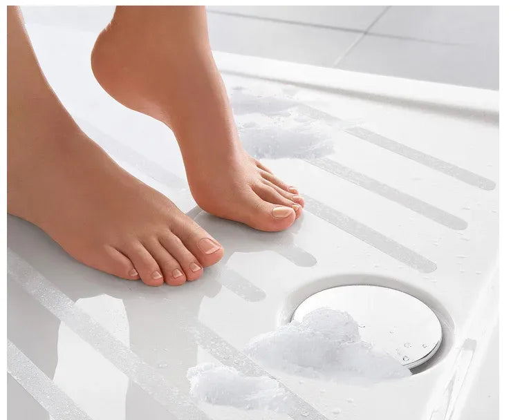Clear anti-slip bathtub safety tape strips on tub floor for secure footing