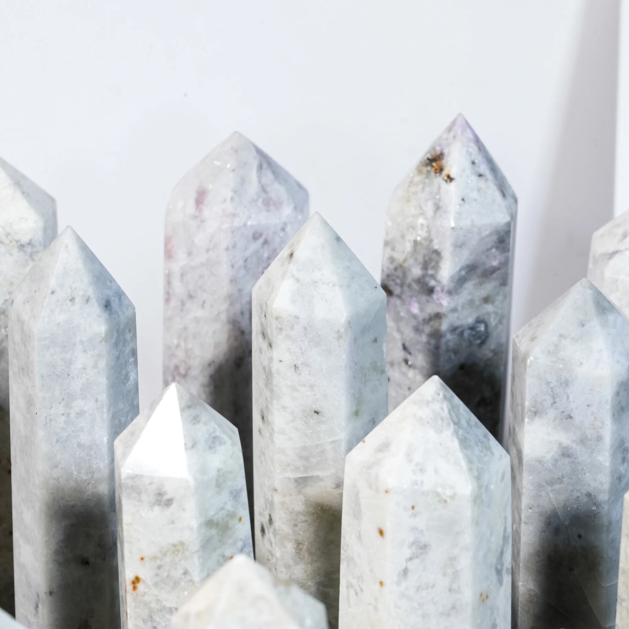 Natural gemstone crystal point tower close-up with tall faceted pointed crystals.