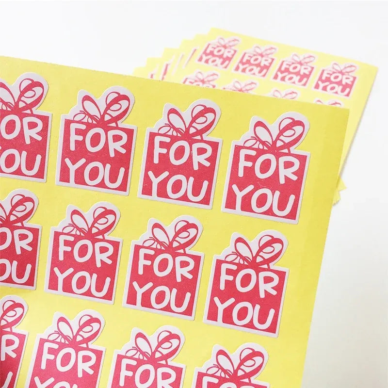 Pink 'For You' sealing stickers sheet close-up, gift-box and bow icons