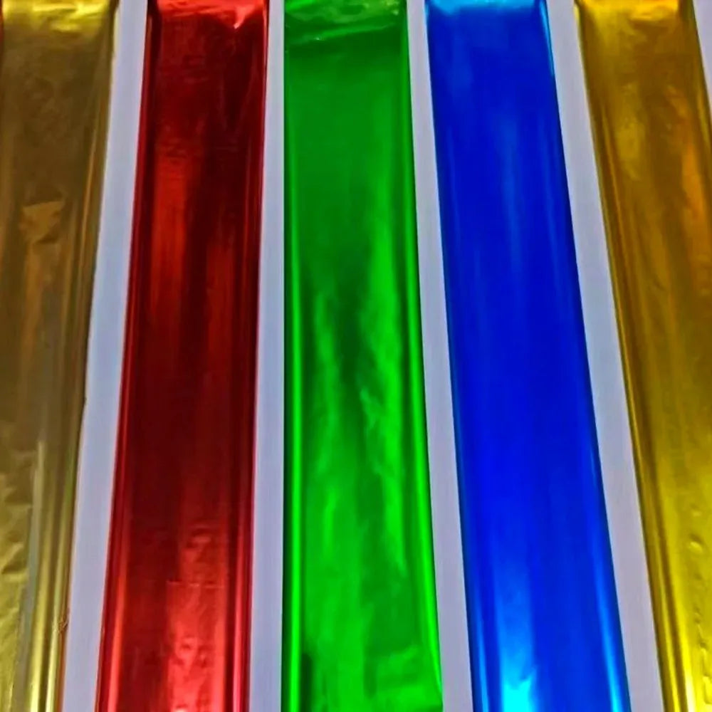 Metallic foil ribbon strips in gold, red, green, and blue, stacked side by side