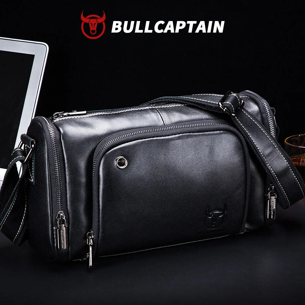 BULLCAPTAIN black cowhide leather trunk messenger bag with zip pockets, crossbody strap, and embossed bull logo.