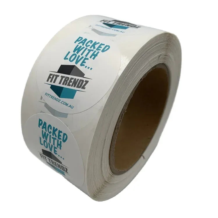 White roll of custom printed packaging label stickers with blue text logos