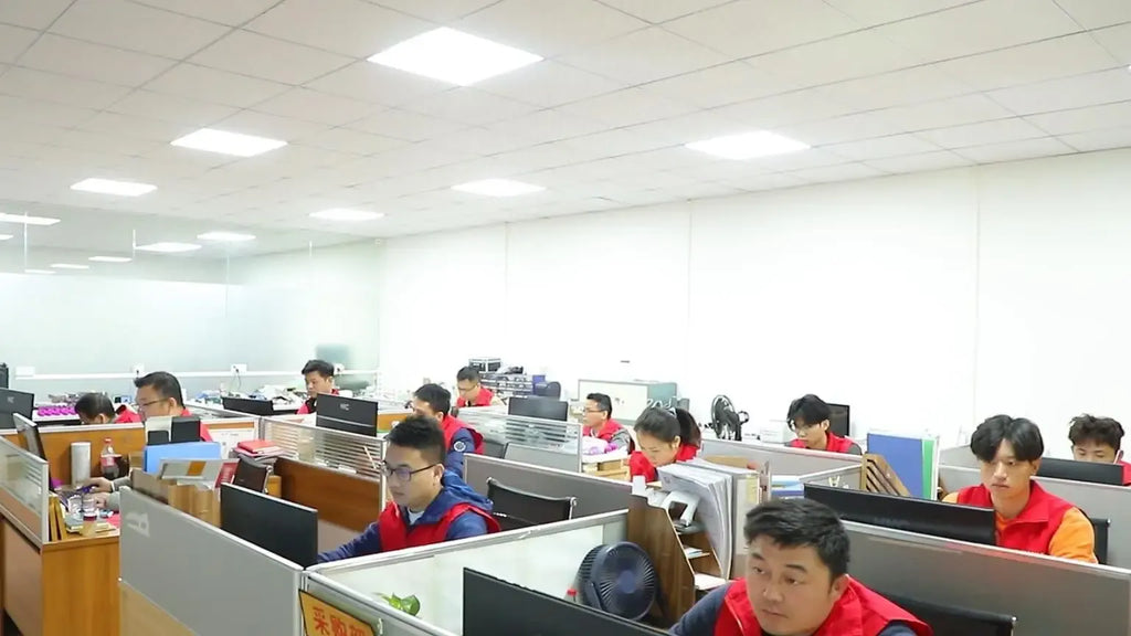 Office workshop interior with rows of desks and seated workers