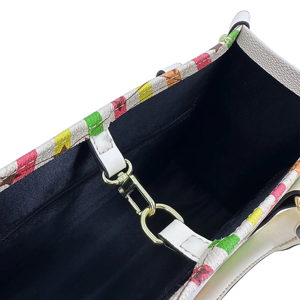 Vintage leather trunk handbag with multicolor pattern, white trim, and gold logo hook closure interior.