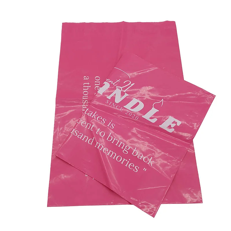 Pink printed poly mailer bags with white candle logo and quote text